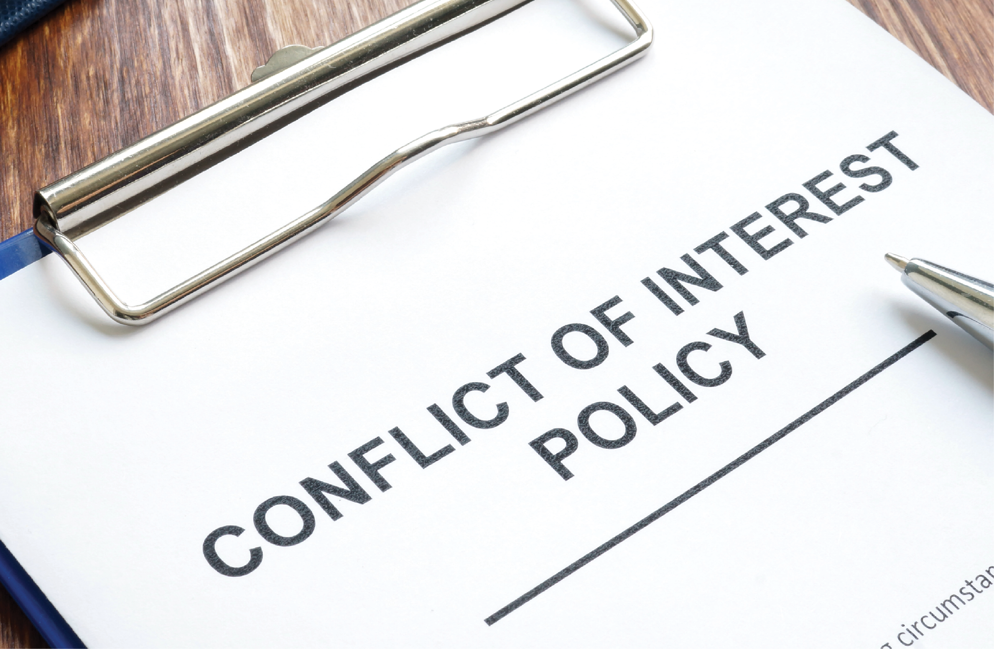 Paperwork titled “Conflict of Interest Policy” is on a clipboard. 