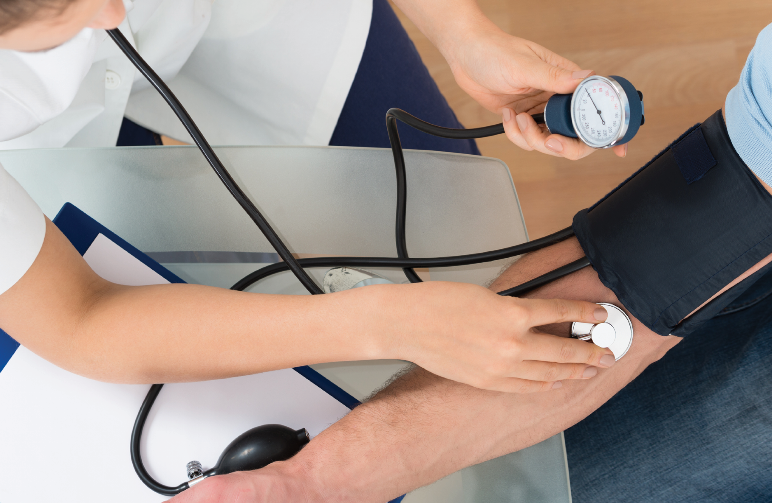 A nurse checks a patient's blood pressure. 