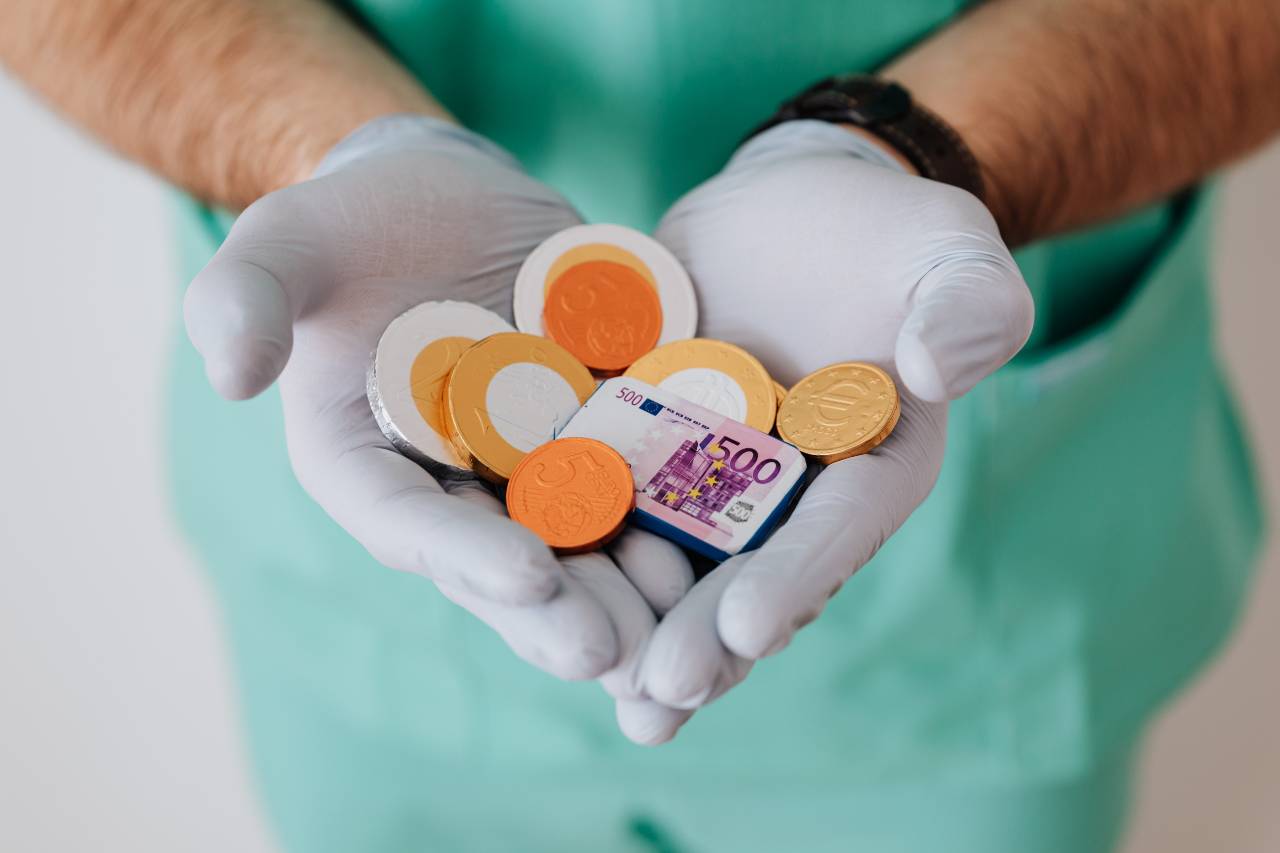 Gloved hands full of money 