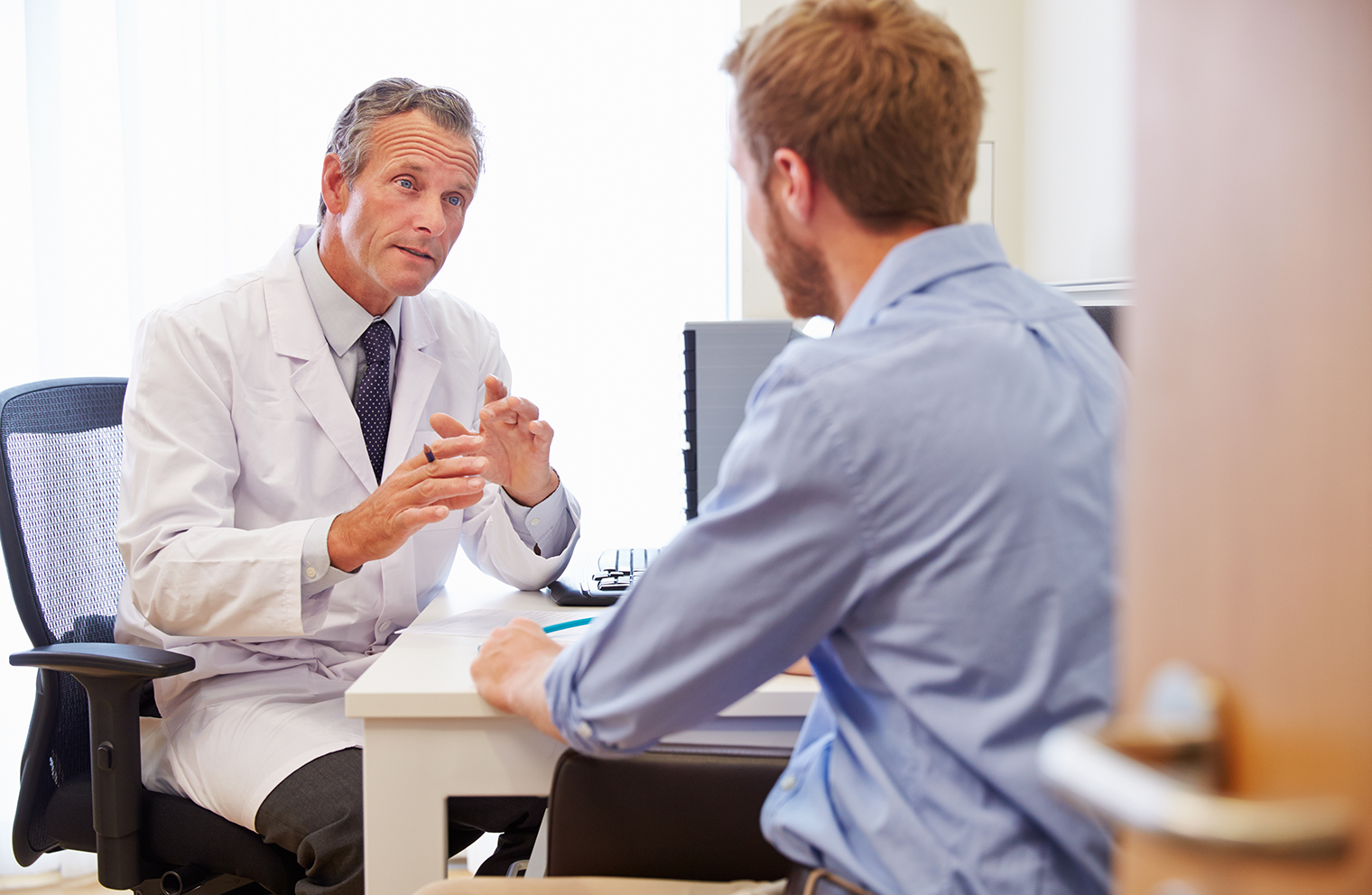 A patient speaks with a doctor about preventive and diagnostic care.