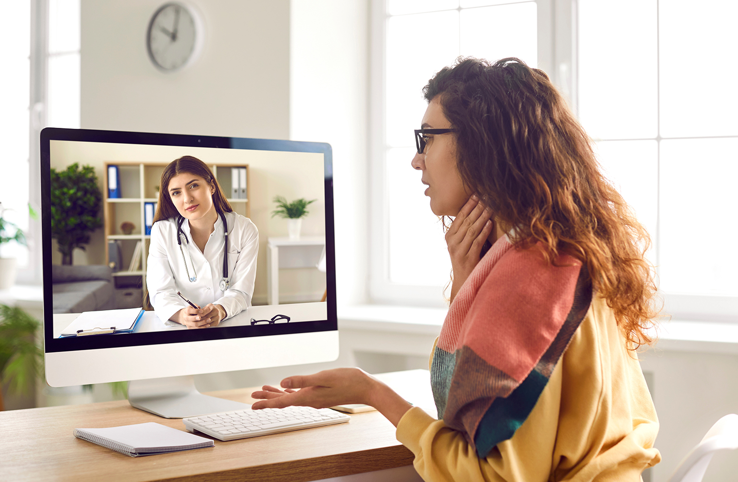 A woman with a sore throat uses telemedicine for health care services. 
