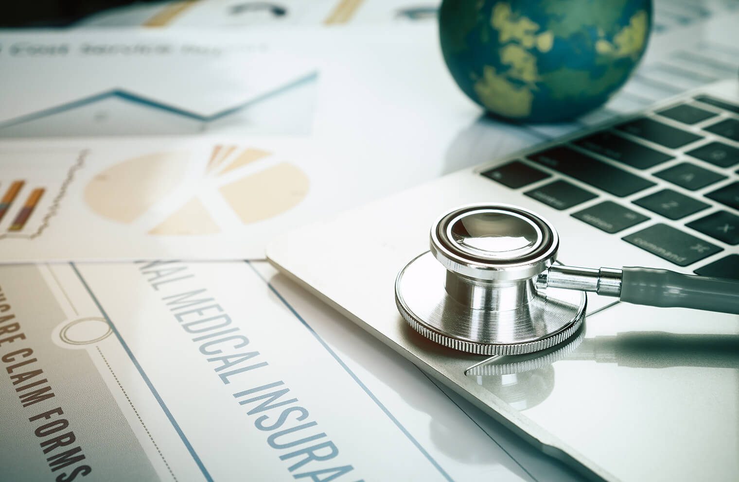 A stethoscope and health insurance paperwork. 