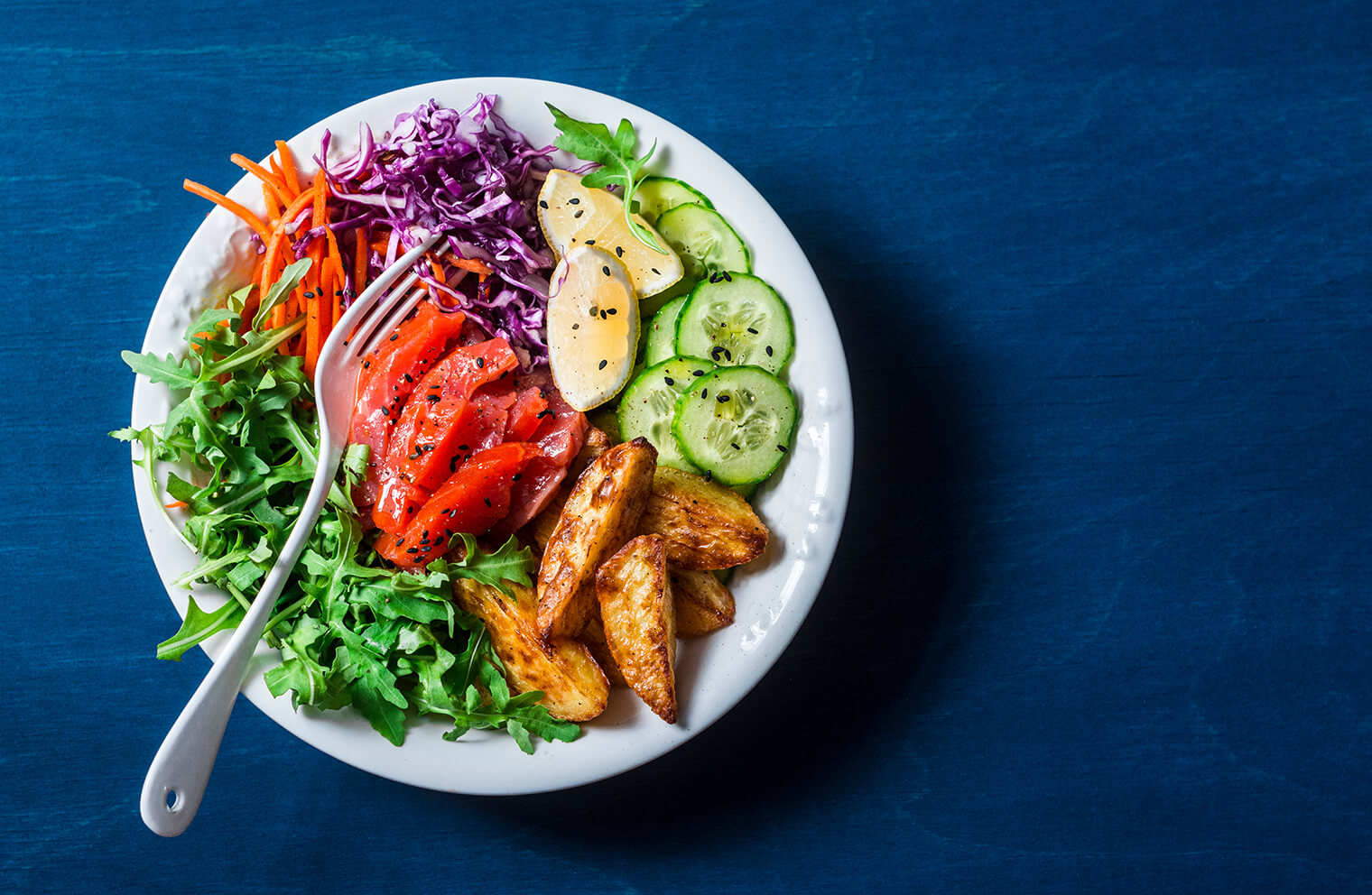 Picture of a bowl of colorful salad with a fork.