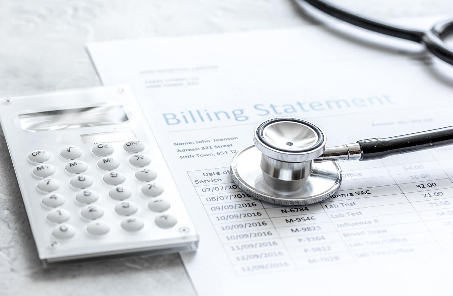 Picture of a calculator and a stethoscope on top of a document titled, "Billing Statement".