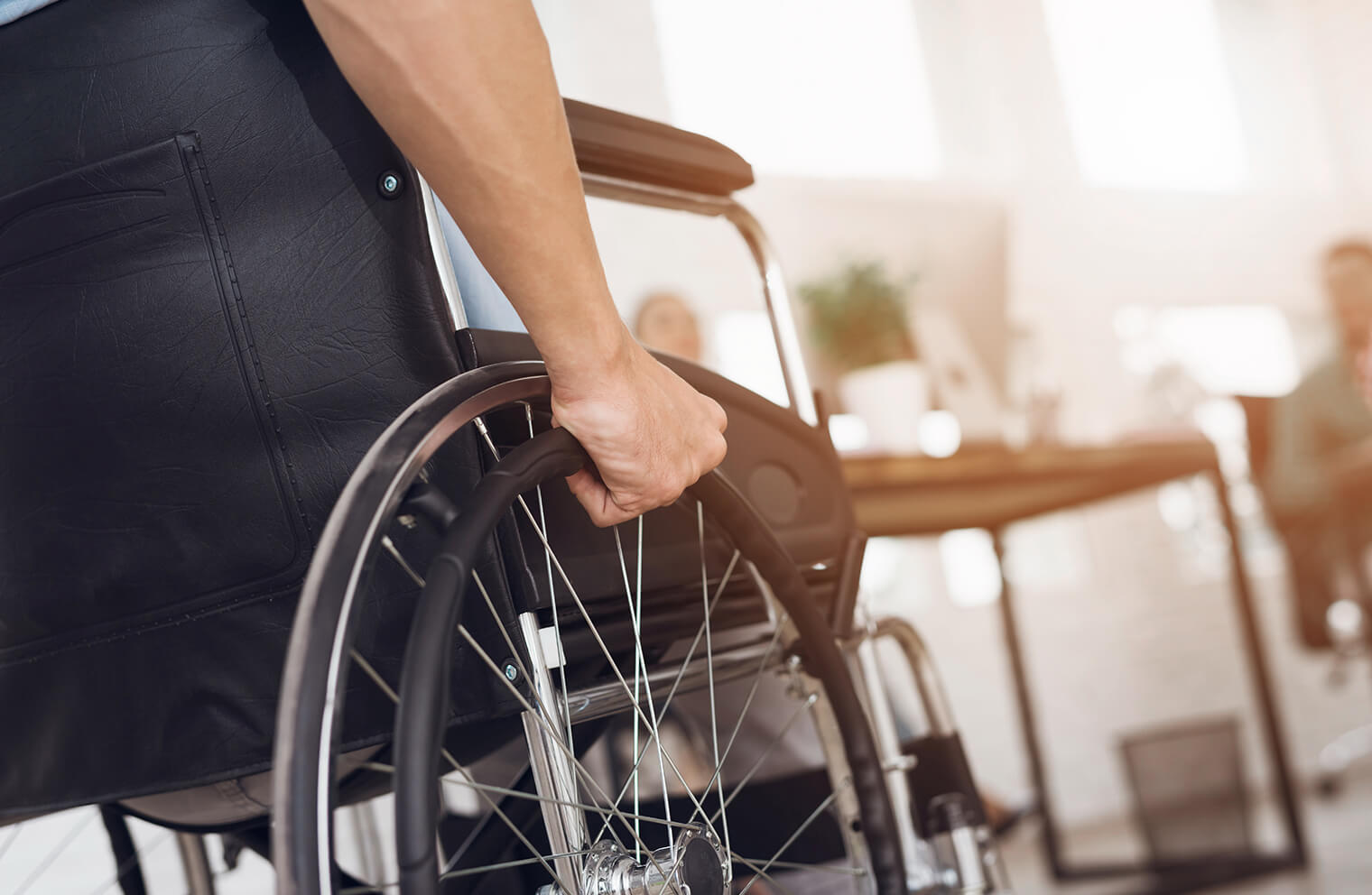 Picture from the perspective of being behind a person in a wheelchair as they push their wheels.