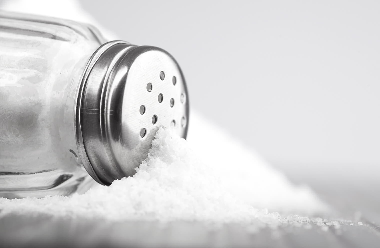 Close up picture of salt coming out of a salt shaker.