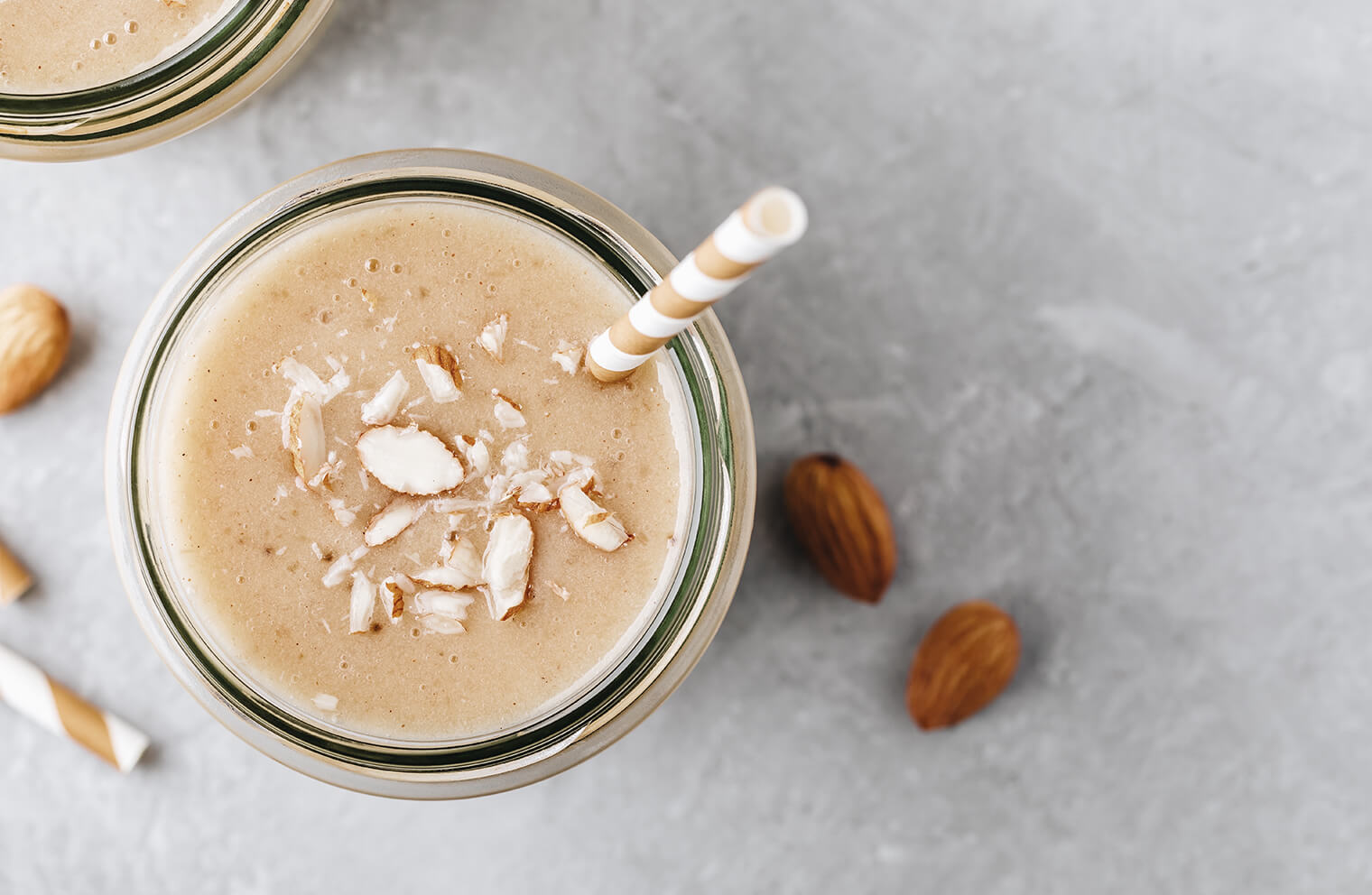 Picture of the top of a brown smoothie with almonds.