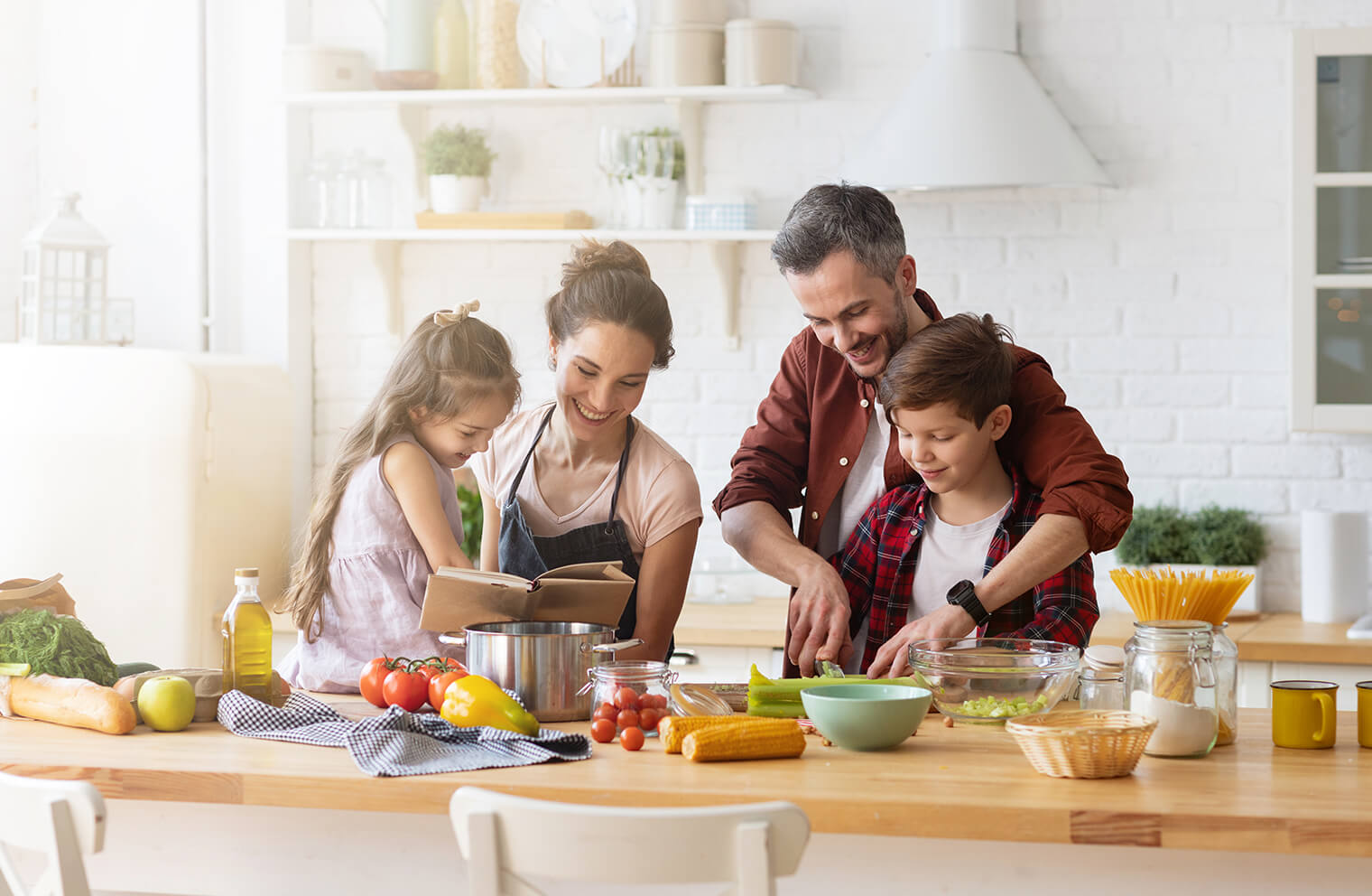 Picture of a young family with one boy and one girl cooking together in the kitchen.