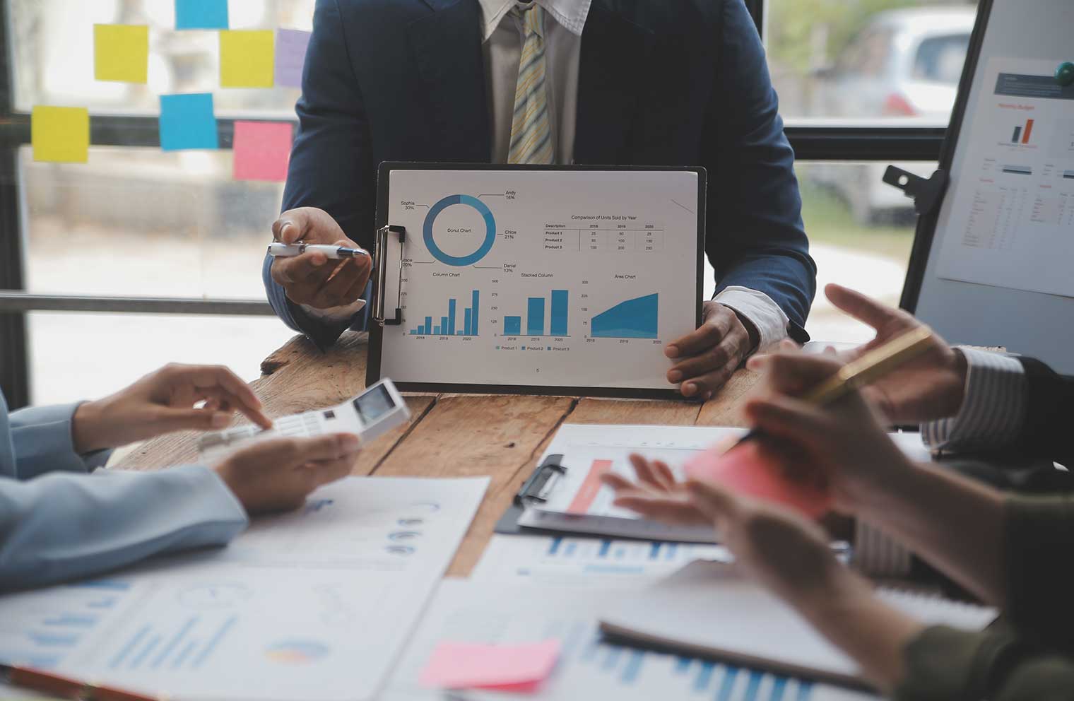 man displaying graph of data to boardroom