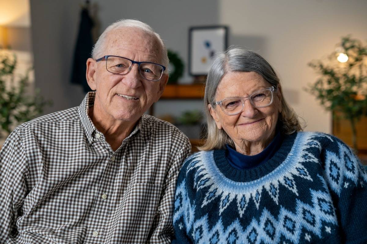 Retired pastor and his wife sitting together in their home