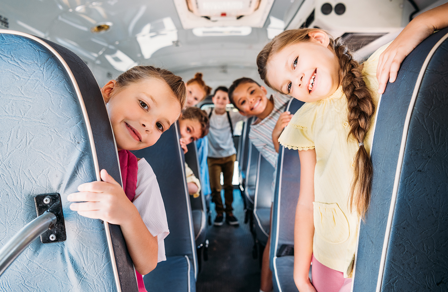 A group of kids ride in a van to church camp.