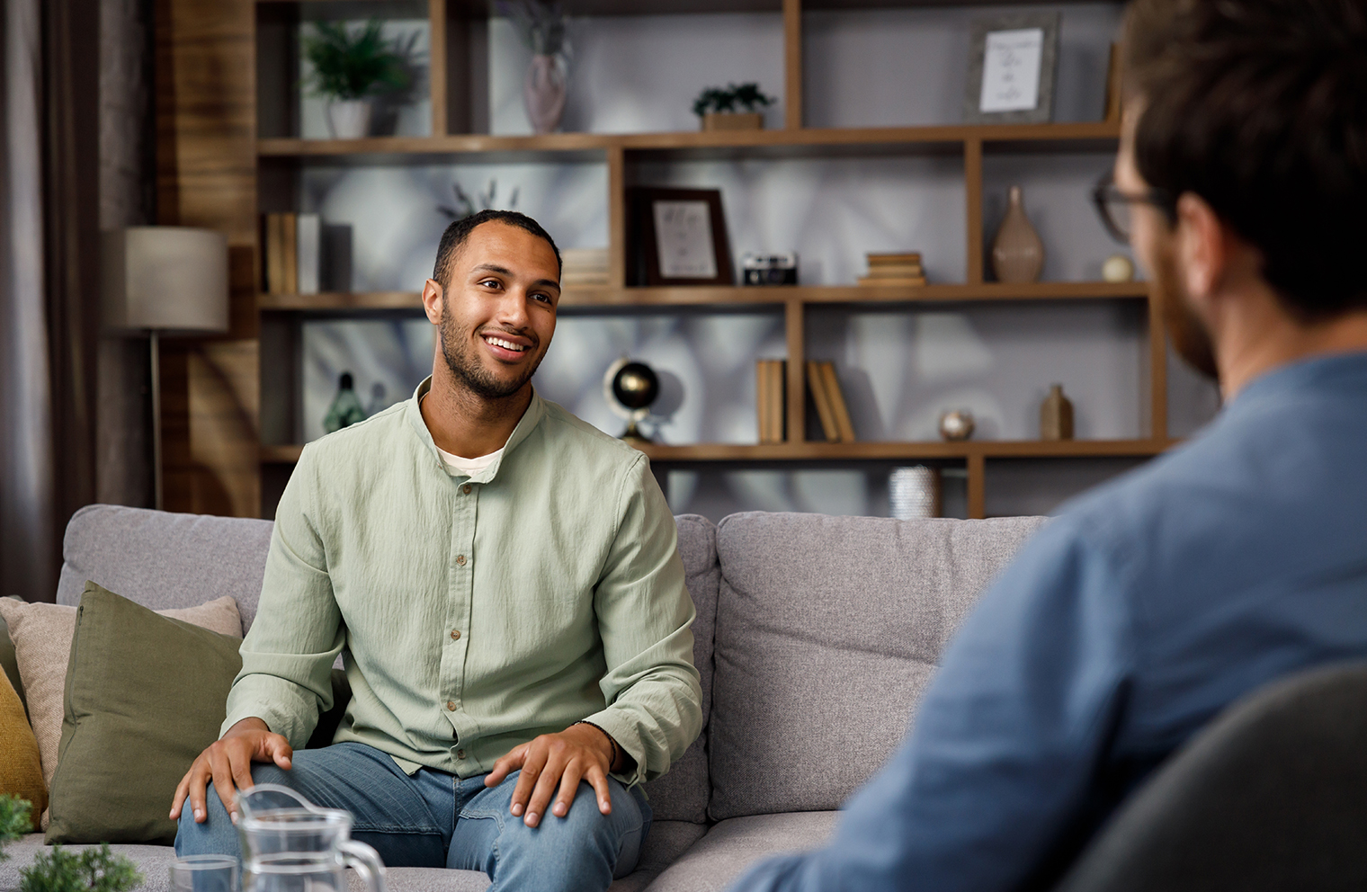 A pastor counsels a man in his office. 
