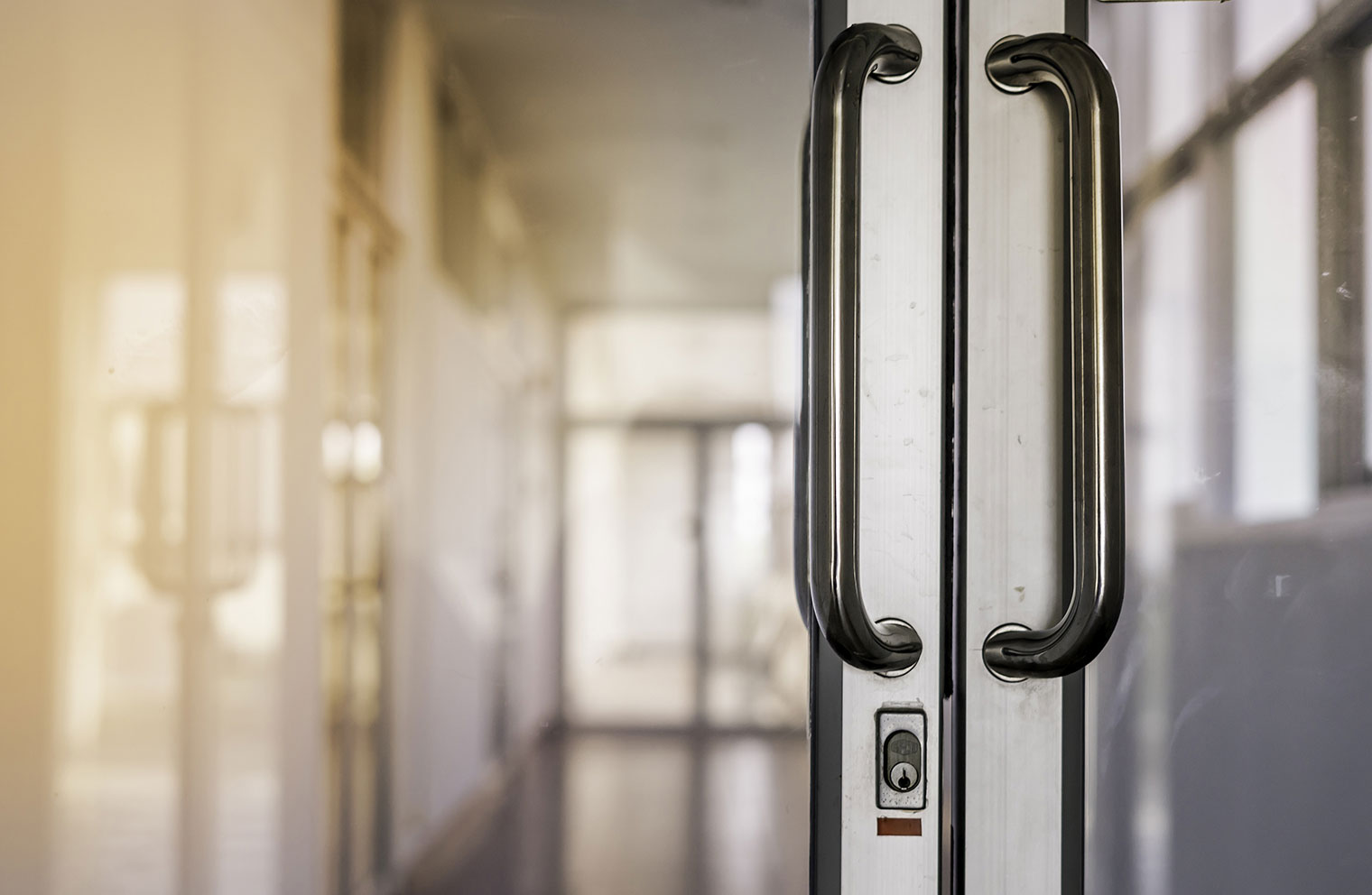 Double glass doors featuring a lock. 