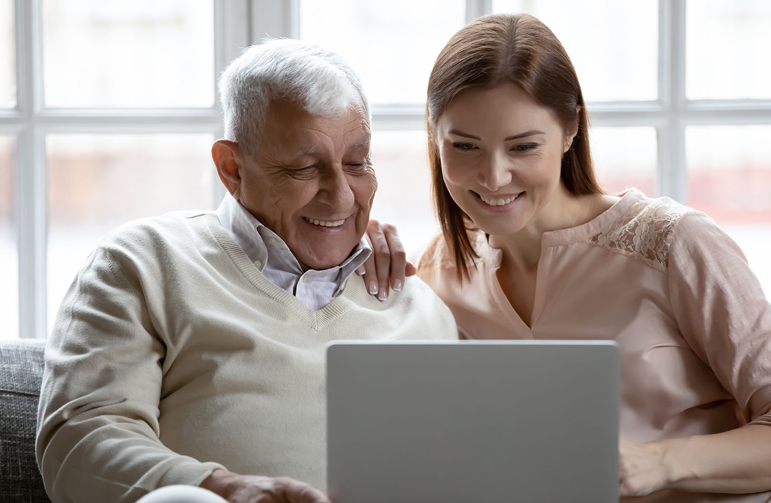 Image of father and daughter looking at a laptop together