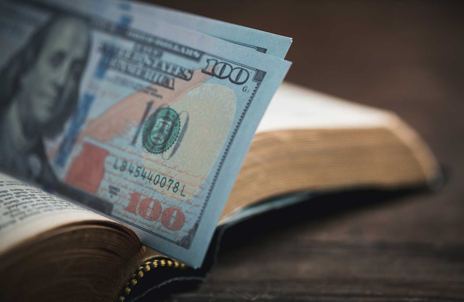 Picture of a $100 bill and a bible.