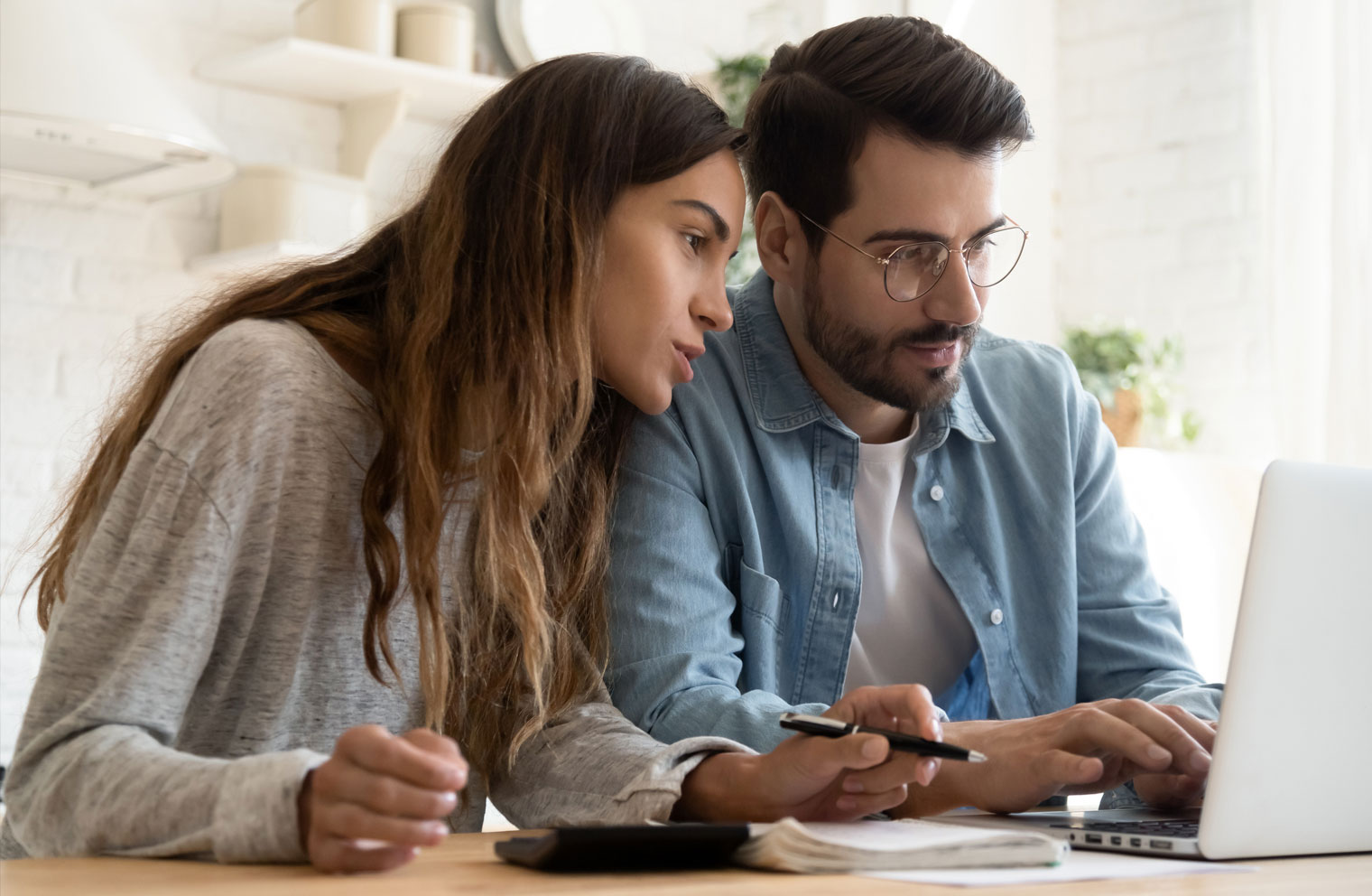Image of young couple working on computer together at desk