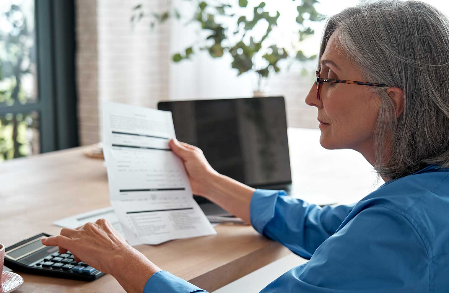 Woman reviewing a bill with a calculator