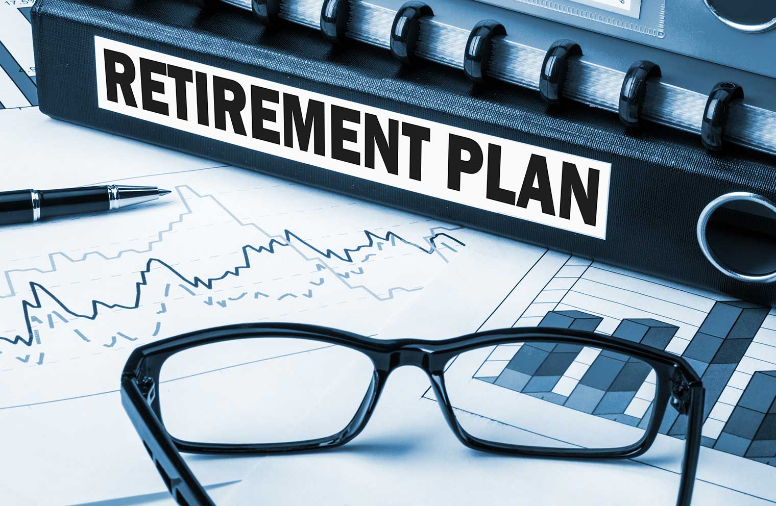 Paperwork with a binder labeled Retirement Plan