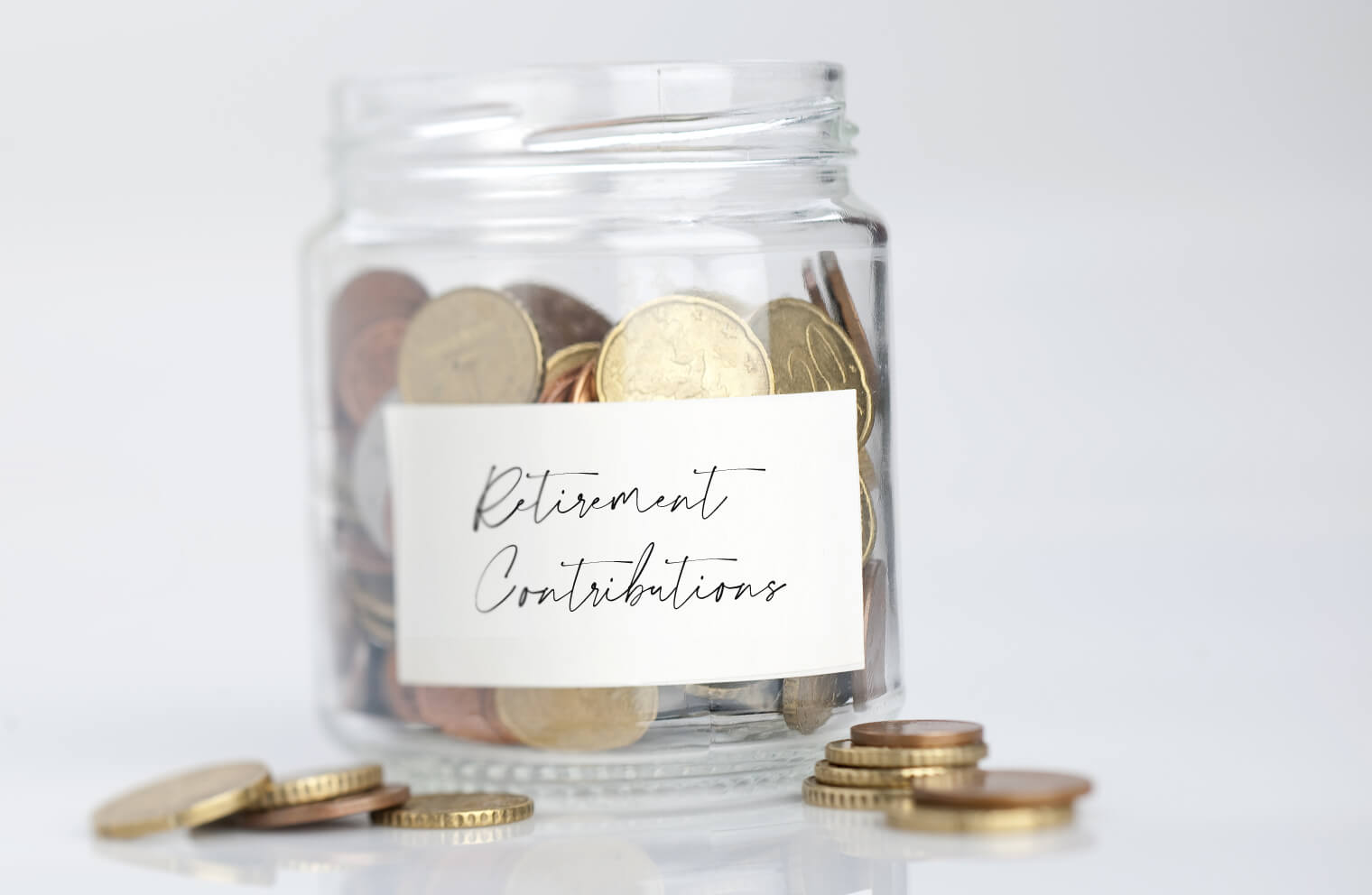 Picture of jar with money and coins that says, "Retirement Contributions."