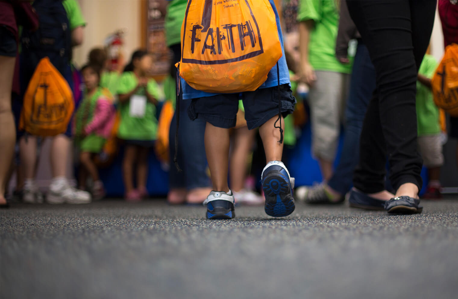 Close up picture of a child walking into a VBS classroom.